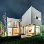 Amusing Building Design of Modern Valna House with White Colored Outer Concrete Wall and Vast Garden filled with Grass