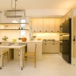 Appealing Kitchen Design on Modern Apartment with Several Soft Cream Colored Cabinets which are Made from Wood and Soft Yellow Backsplash Lamp