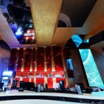 Appealing View of the Sky Club Romania with Red Wall and White Bar Counter near Blue Light