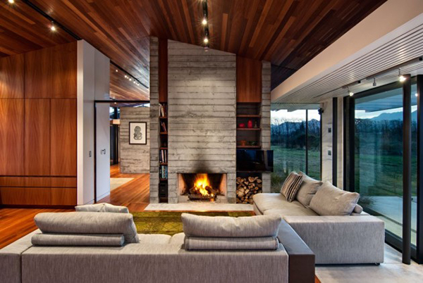 Astonishing Living Space Design of Pavilion Wairau House with Soft Grey Colored Concrete Chimney Wall and Dark Brown Wooden Ceiling