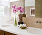 Beautiful Pink Flowers in the Brentwood Residence Bathroom with Long Wooden Vanity and the White Sinks