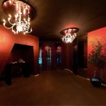 Bright Chandelier and Red Wall in the Sky Club Romania Alleyway with Brown Ceiling and Brown Floor
