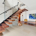Bright White Arc House Maziar Behrooz Living Room Displaying Floating Staircase with Gridded Wall