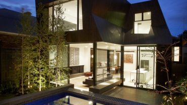 Contemporary Night View of the Eh 280113 House with Bright Interior Lighting and Wide Glass Walls