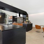 Dark Black and Light White Themed Arc House Maziar Behrooz Kitchen and Dining Room with Industrial Pendant