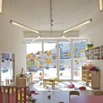 Fascinating Play Center Children with Glaring Shiny Neon Pendant Lights above Kids Playroom Furnished Wood Cabinet and Colorful Dining Set