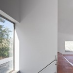 Interesting Interior of the JM Casa Odemira with White Wall and Wide Glass Windows near Green Tree