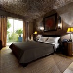 Interesting Luxury Resort Bedroom Exotic View with Black Bed and Grey Quilt on Brown Carpet and Wooden Floor