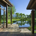 Relaxing Lake House with Gorgeous Lake and Mountainous View Lacquered Wood Deck Rough Stone Wall Reflecting Natural Sense