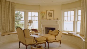 Classic Design Idea Applied on Face to Face Chair in Small Living Space with White Colored Fireplace Mantel Design and Glass Window