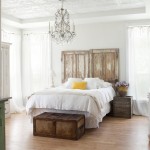 Classic Chandelier above White Bed in Old Fashioned Bedroom with Farmhouse Style Furniture