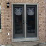 Classic Metal Details on Appealing French Door Options in Interesting Brick Wall with Small Wall Lamp