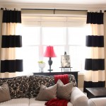 Comfortable Sitting Room with White Sofas and Fluffy Cushions near Black Cabinet and Black and White Curtains