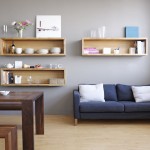 Comfy Lounge with Blue Sofa and Simple Wooden Floating Shelves IKEA beside Grey Painted Wall