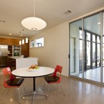 Fascinating Orange Chairs and Round Table under Modern Pendant Lighting Fixtures for Small Open Dining Room