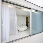 Gorgeous Bathroom View behind Modern Sliding Door Design with Wide Size and Glass Panel on Marble Flooring