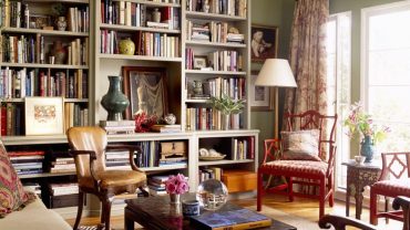 High Wooden Booskshelves in Bohemian Apartment Decorating Ideas with Teak Armchairs and Dark Table