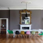 Luxurious Wall Mirror facing Long Table and Colorful Chairs in Dining Area using Retro Interior Design Ideas