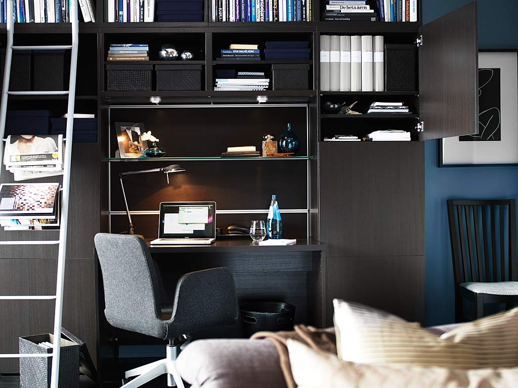 Modern Dark Desk and Grey Swivel Chair under Black Bookshelves for Stylish Small Workspace Designs