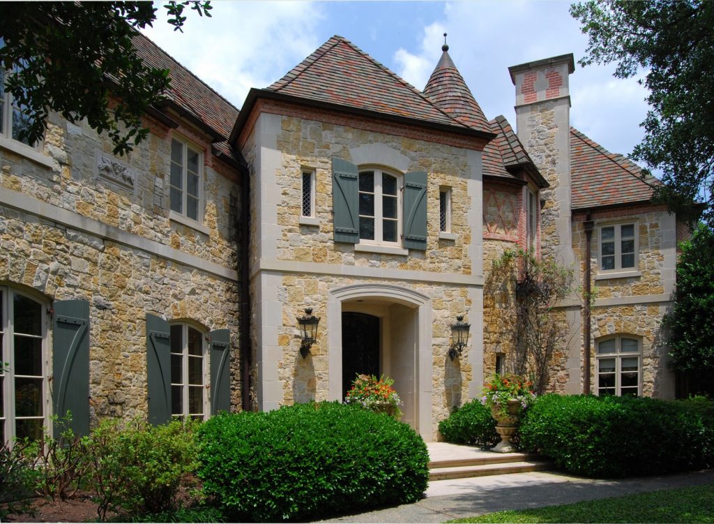Natural Green Plantations near French Country Inspired Homes Facade with Stone Wall and Classic Windows
