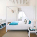 Relaxing White Canopy Bed for Beach Bedroom Themes with White Bedside Tables and Unique Table Lamp