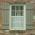 Rustic Exterior Window Shutters in Grey Color for Traditional White Framed Glass Windows