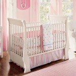 Sensational White Crib and Pink Clothes between White Armchair and Table for Baby Girls Rooms