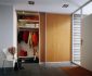 Simple Sliding Closet Doors Ideas using Wood Material near White Shelves and Jackets Hanger