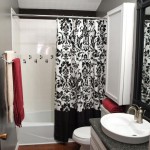 Small Bathroom with White Vanity and Granite Top near Black and White Curtains and White Bathtub
