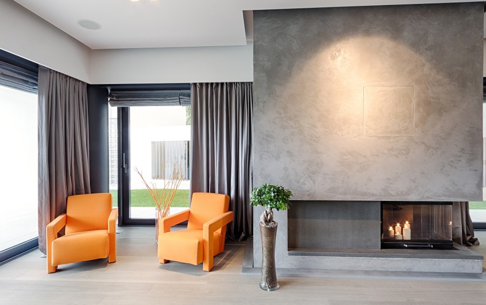 Spacious Area with Orange Armchairs and Modern Fireplace near Grey Curtains for Sliding Glass Doors