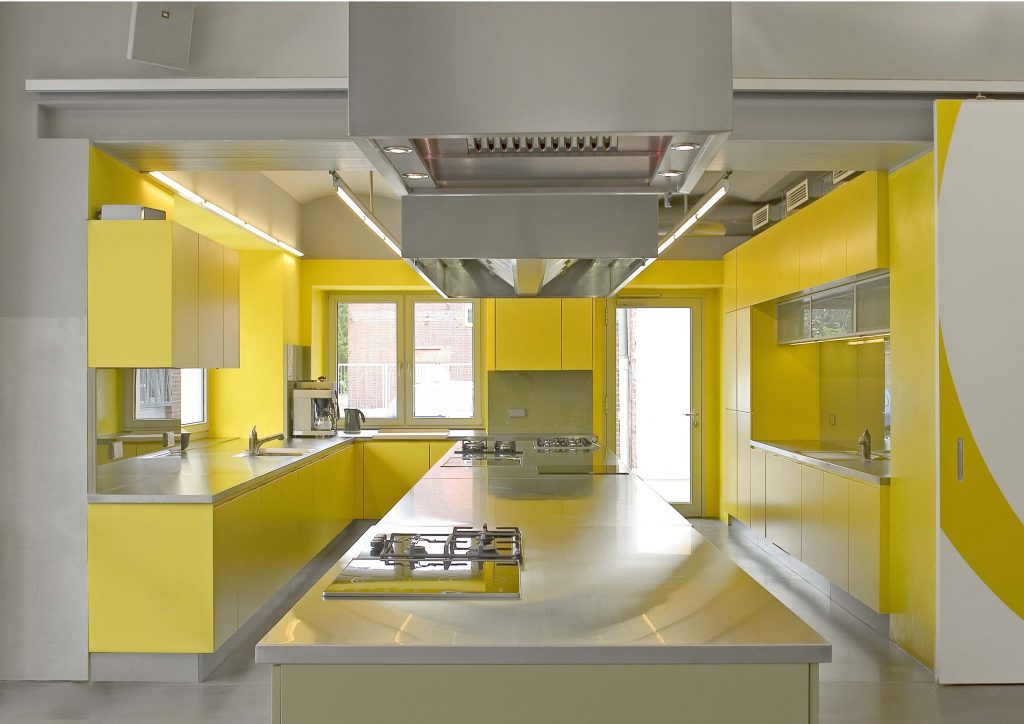 Wonderful Yellow Interior Design Ideas for Kitchen with Long Island and Yellow Cabinets beside Windows