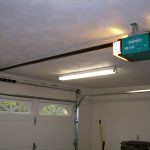 Appealing Dark Holder to Garage Door Opener with Lamp Design at Building Interior Schemes