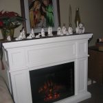 Divine White Electric Fireplace Design with Miniatures and Planter at Modern House Design