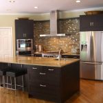 Stylish Kitchen with Most Popular IKEA Kitchen Cabinets and Dark Island on Laminate Wood Flooring