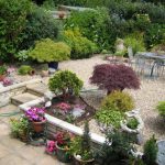 Beautiful Flowers in Awesome Gardens Decorating Ideas with Pebble Yard and Outdoor Dining Area