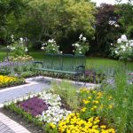 Comfy Bench on Grey Brick Pathway in Beautiful Gardens Decorating Ideas with Colorful Flowers