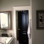 Cozy White Bathtub and Classic Wall Mirror beside Dark Solid Wood Doors Interior inside Small Bathroom