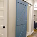 Rustic Sliding House Interior Doors for Old Fashioned Home with Grey Painted Wall and Oak Flooring