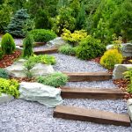 Sensational Gardens Decorating Ideas with Pebble Pathway and Log Stairs between Green Plantations