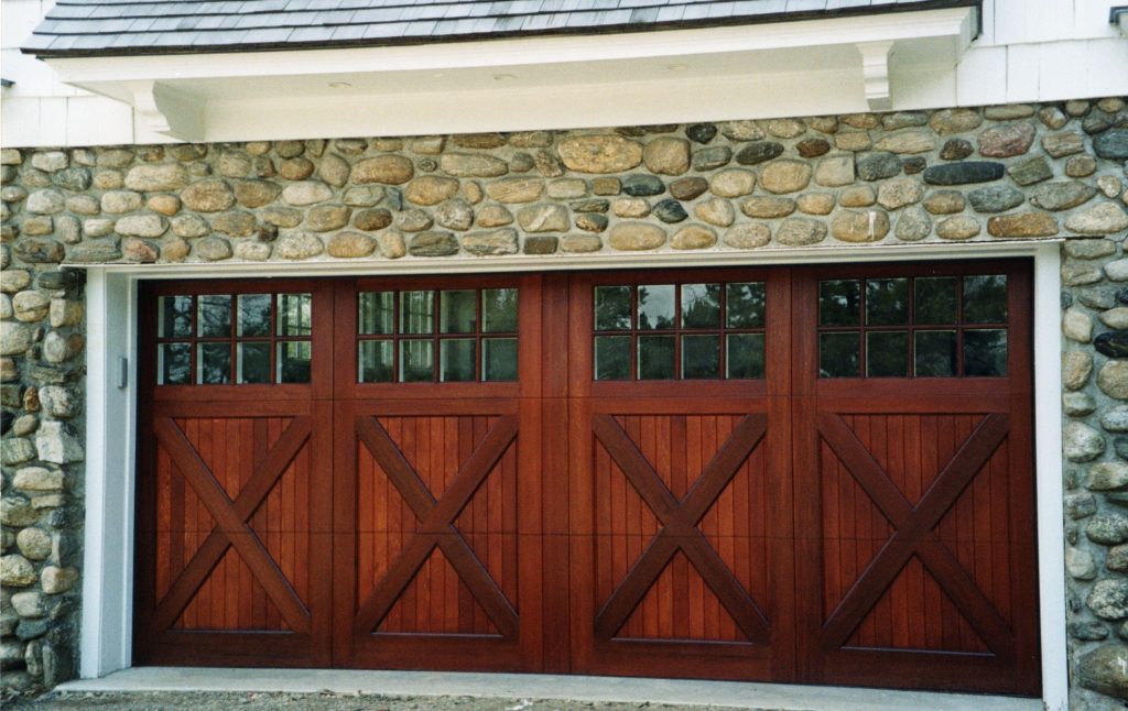 Adorable Wooden Carriage Style Garage Doors Design in Best Stone Wall plus Glass Accent