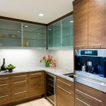 Affordable Design of L-Shape Kitchen Cabinet Glass Doors and Granite Countertop also Fresh Flowers