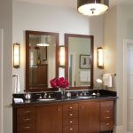 Dainty Wooden Cabinet with Dark Countertop also Alluring Bathroom Mirrors Design Ideas betwee Wall Lamps