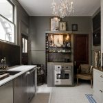 Eclectic Style of Grey Kitchen Cabinets also Dark Backsplash plus Comfirtable Arm Chairs