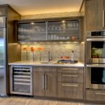 Interesting Style of Grey Kitchen Cabinets using Natural Stone Backsplash plus Sliding Glass Door