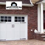 Simple Pure Carriage Style Garage Doors in Large Brick Wall plus Black Glass Accent