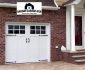 Simple Pure Carriage Style Garage Doors in Large Brick Wall plus Black Glass Accent