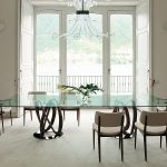 Stylish Chandelier above Big Glass Classic Dining Table Designs with Cute Chair and Big Door