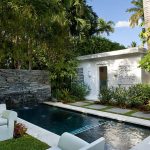 White Sofa on Green Grass plus Classic Stone Fence fit to Small Swimming Pools Designs