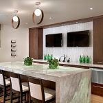 Awesome Kitchen with Wall Flatsceen Televisions Completed with Modern Kitchen Islands and High Chairs