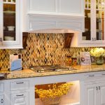 Amazing Backsplash Designs Nuanced in Glamorous Gold Created in White Kitchen on Hardwood Flooring